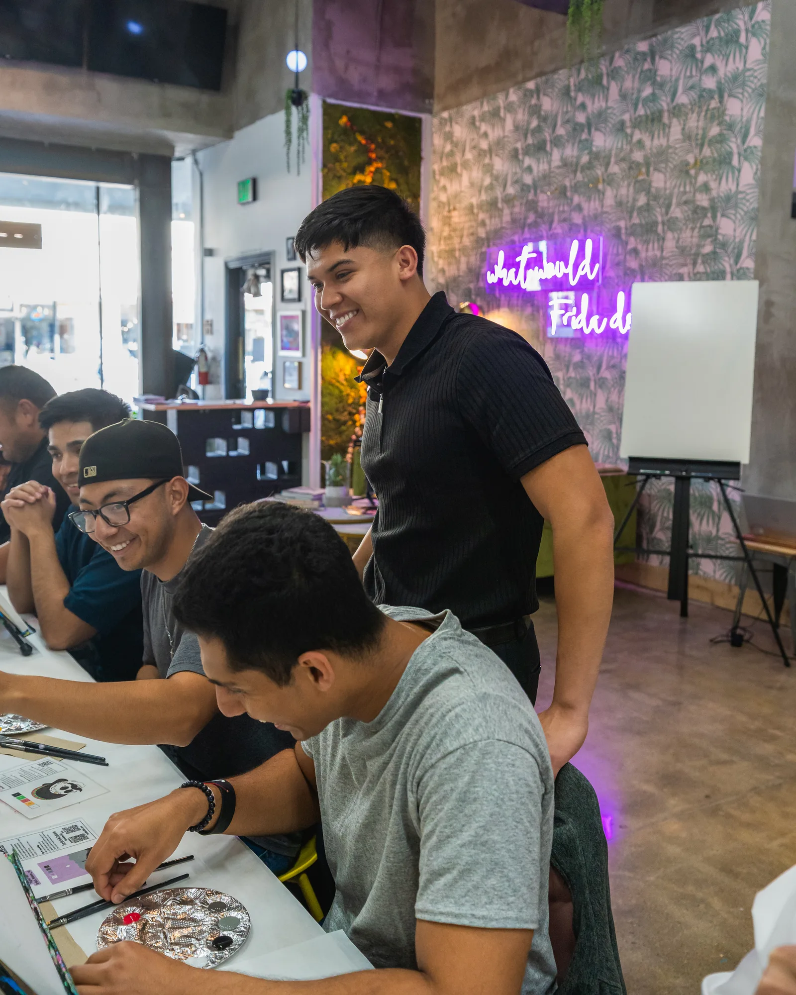 Eliam laughing with attendees at his communication workshop