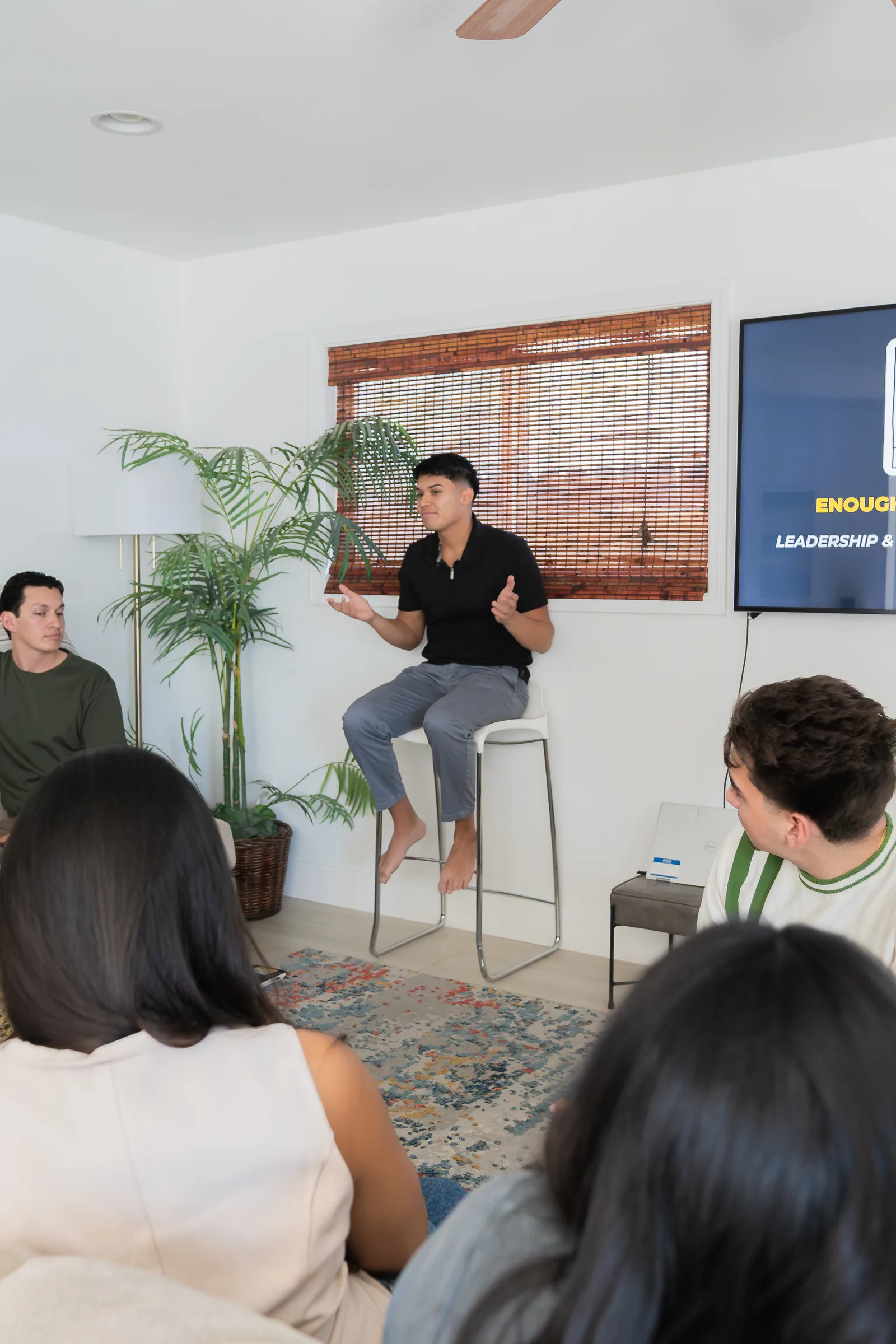 Eliam teaching Enough Is Enough to a seated group